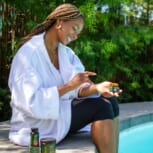 YOUNG-BLACK-WOMAN-BY-POOL-WITH-CBD-3-PRODUCT-BUNDLE